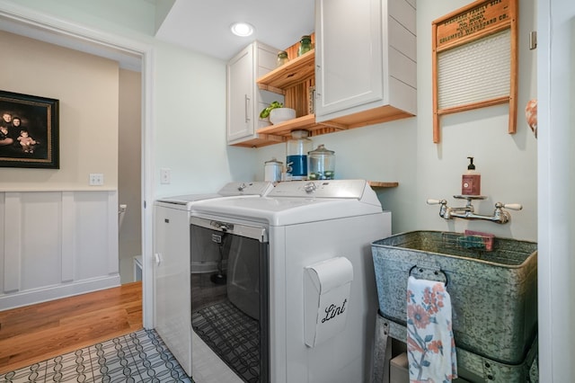 laundry room with washing machine and clothes dryer, recessed lighting, and cabinet space