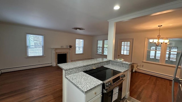 kitchen with electric stove, light stone countertops, and a baseboard heating unit