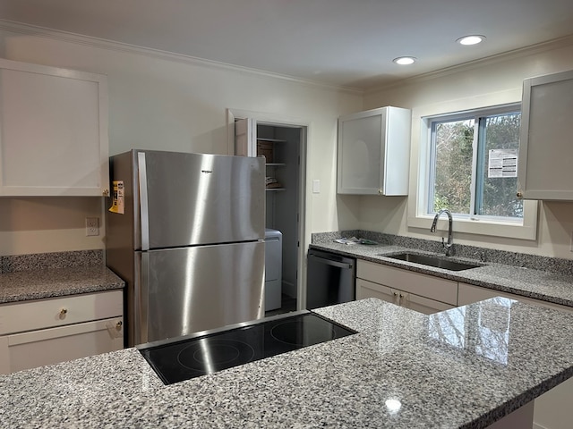 kitchen with stainless steel refrigerator, white cabinetry, sink, dishwashing machine, and light stone countertops