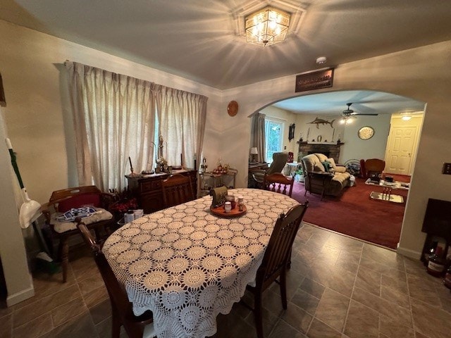 carpeted dining room featuring ceiling fan