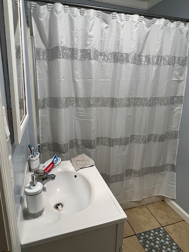 bathroom featuring tile patterned flooring, vanity, and curtained shower