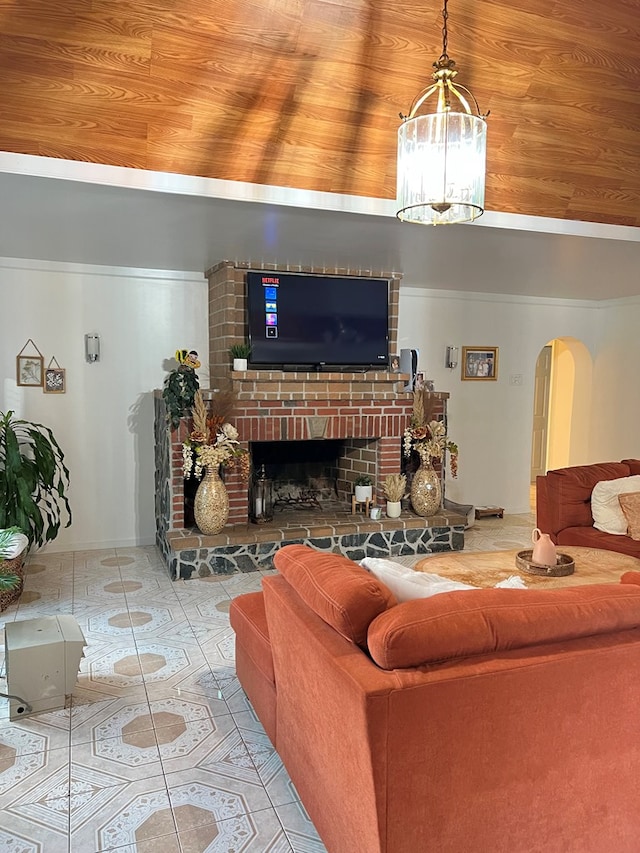 living room featuring arched walkways, lofted ceiling, a fireplace, tile patterned floors, and an inviting chandelier