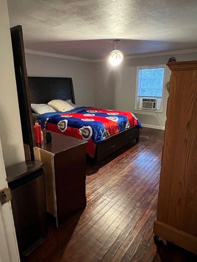 bedroom with wood-type flooring, a textured ceiling, crown molding, and cooling unit