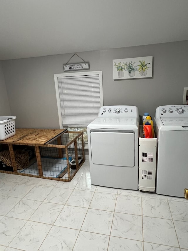 laundry area featuring washer and dryer, marble finish floor, and laundry area