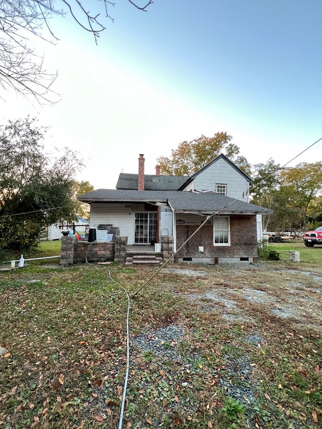 rear view of house with a chimney