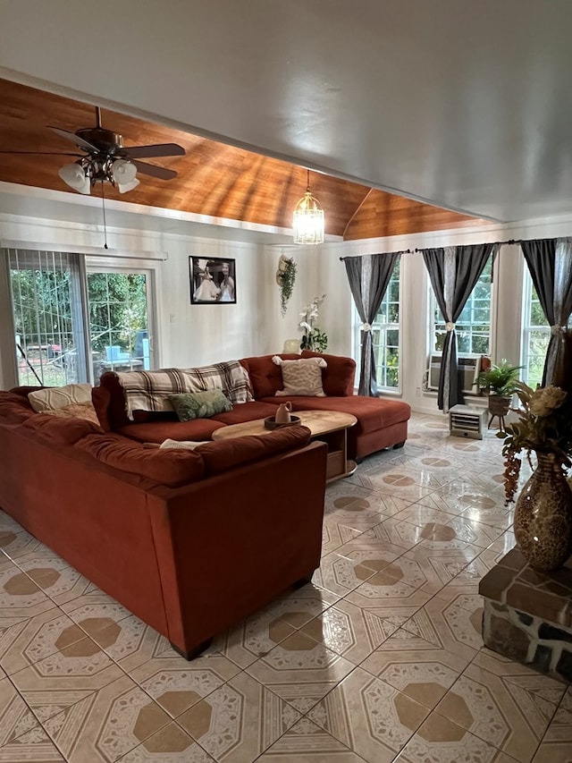 living room featuring lofted ceiling and ceiling fan with notable chandelier