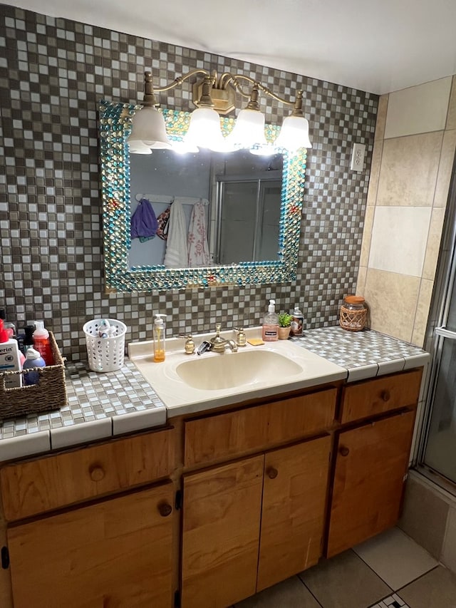 bathroom with tasteful backsplash, an enclosed shower, vanity, and tile patterned floors