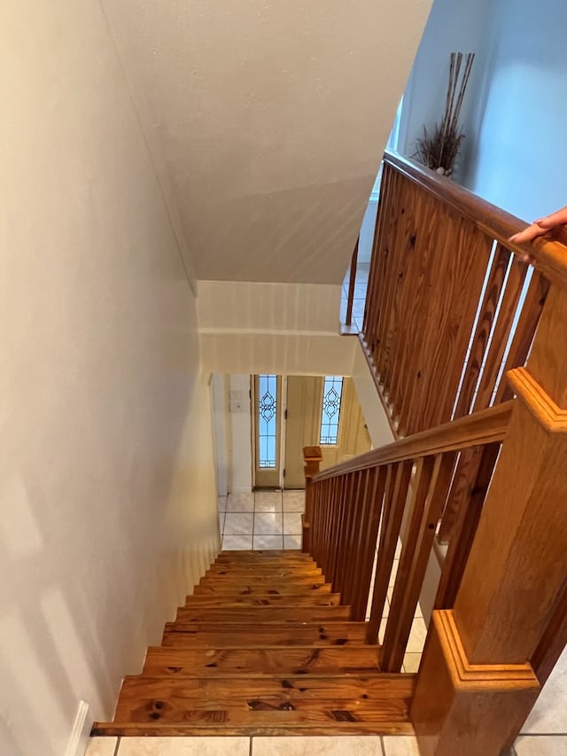 stairway with tile patterned floors