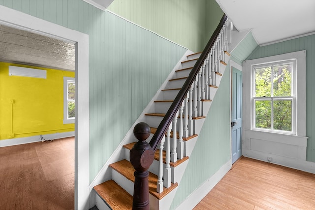 14457 Broadway Rd, Onancock, VA 23417 - stairway featuring a wall unit AC and wood finished floors