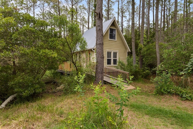 14457 Broadway Rd, Onancock, VA 23417 - view of side of home featuring a metal roof and a wooden deck