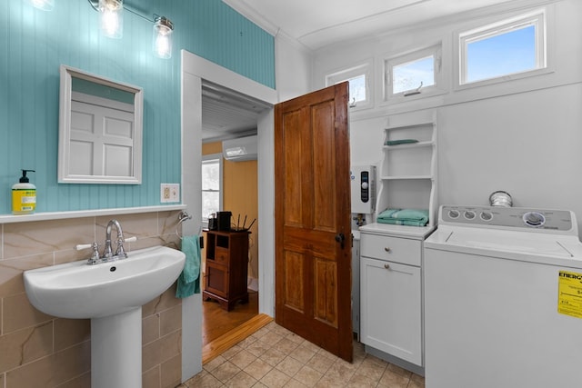14457 Broadway Rd, Onancock, VA 23417 - laundry area featuring washer / clothes dryer, crown molding, light tile patterned floors, and a wall mounted air conditioner