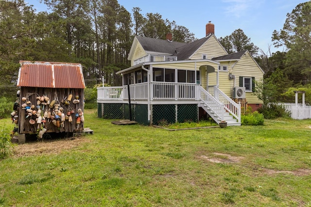 14457 Broadway Rd, Onancock, VA 23417 - rear view of property featuring a sunroom, a chimney, crawl space, stairway, and a shed