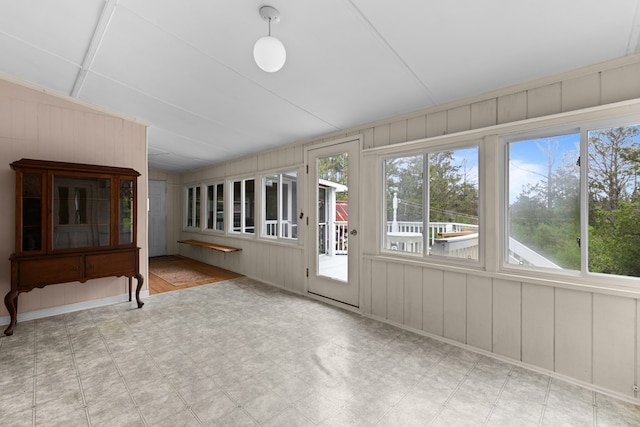 14457 Broadway Rd, Onancock, VA 23417 - unfurnished sunroom with tile patterned floors, healthy amount of natural light, wooden walls, and vaulted ceiling