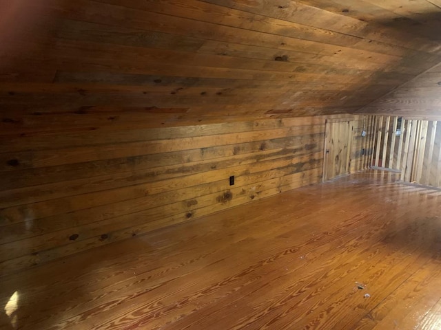 bonus room featuring wood walls, wooden ceiling, vaulted ceiling, and wood-type flooring