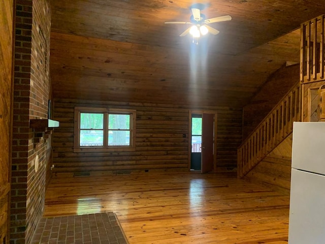 unfurnished living room featuring wood-type flooring, rustic walls, ceiling fan, and wood ceiling