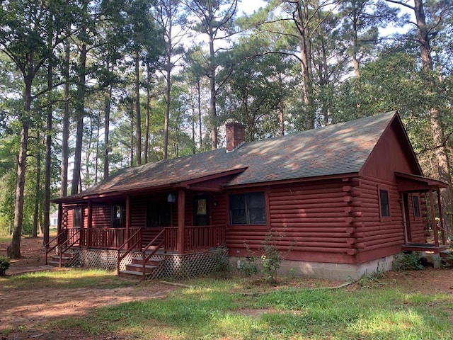 log cabin with a porch