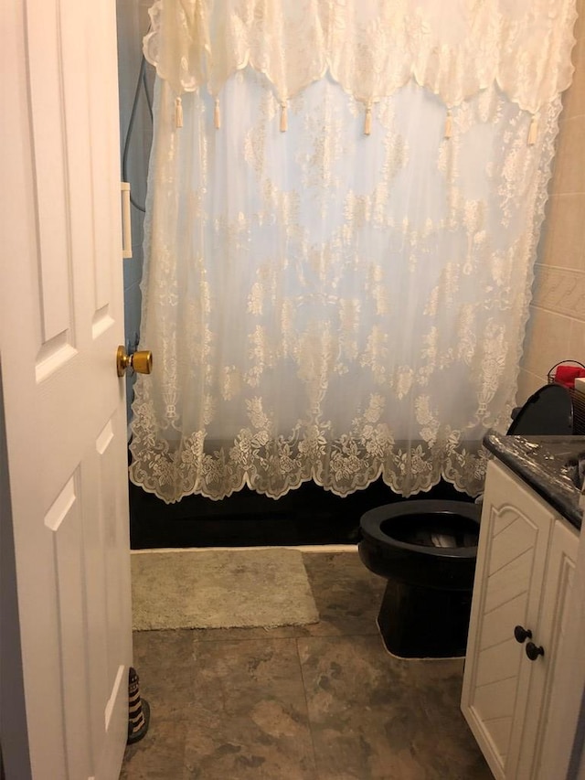 2561 Captains Corridor, Greenbackville, VA 23356 - bathroom featuring vanity, toilet, a shower with curtain, and stone finish floors