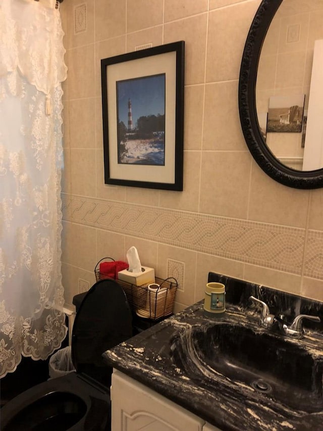 2561 Captains Corridor, Greenbackville, VA 23356 - bathroom featuring toilet, vanity, decorative backsplash, and curtained shower