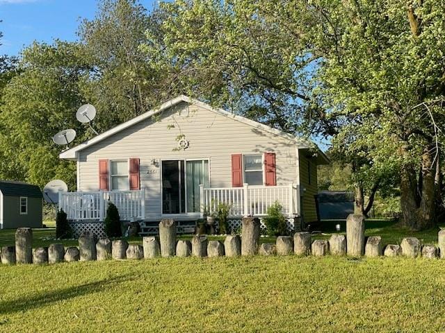 2561 Captains Corridor, Greenbackville, VA 23356 - bungalow-style home with a front lawn and a wooden deck