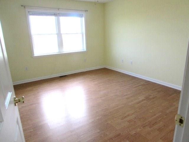 empty room with wood-type flooring