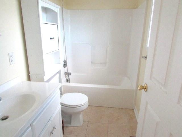 full bathroom featuring vanity,  shower combination, toilet, and tile patterned floors