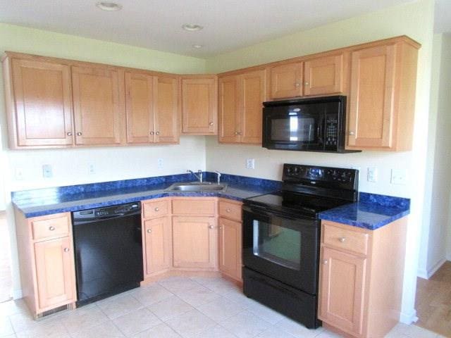 kitchen with sink, black appliances, and light brown cabinets