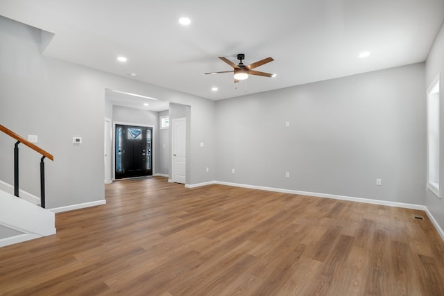 interior space featuring ceiling fan, stairs, baseboards, recessed lighting, and light wood-style flooring