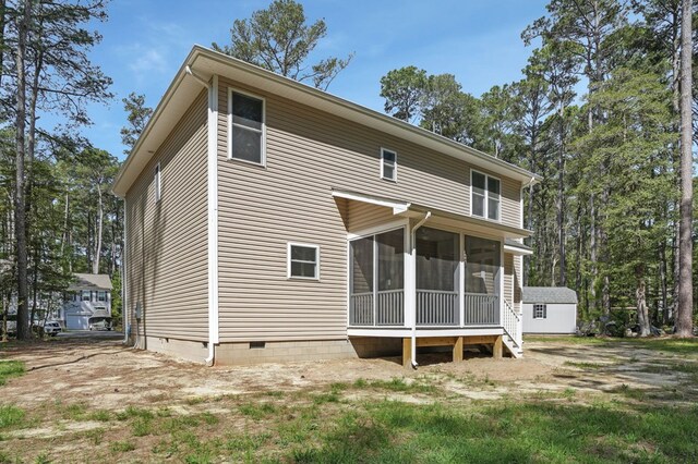 back of property with a sunroom and crawl space