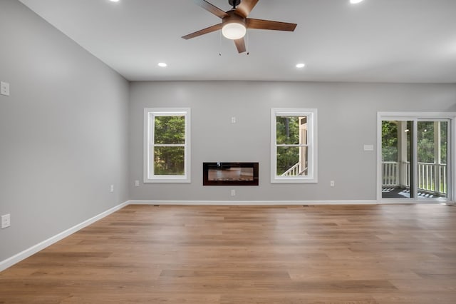unfurnished living room featuring recessed lighting, a ceiling fan, and a wealth of natural light