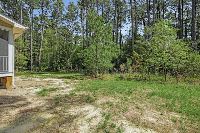 view of yard with a forest view
