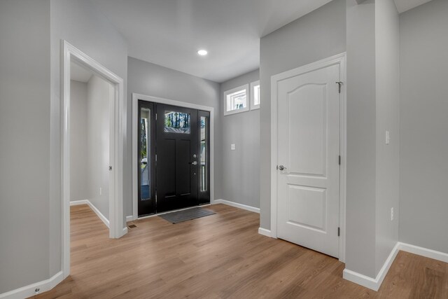 entryway with recessed lighting, baseboards, and light wood-type flooring