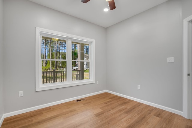 unfurnished room featuring visible vents, baseboards, ceiling fan, and light wood-style floors