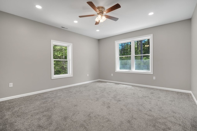 carpeted spare room featuring baseboards, recessed lighting, ceiling fan, and visible vents