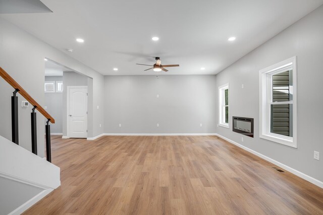 unfurnished living room with a ceiling fan, recessed lighting, and light wood-type flooring