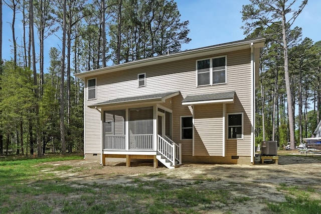 rear view of house with cooling unit, a sunroom, and crawl space