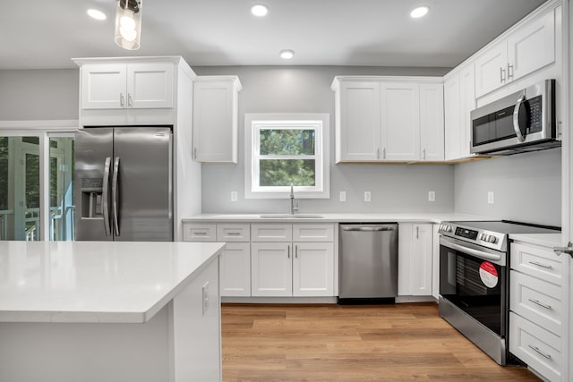 kitchen with white cabinets, recessed lighting, appliances with stainless steel finishes, and a sink