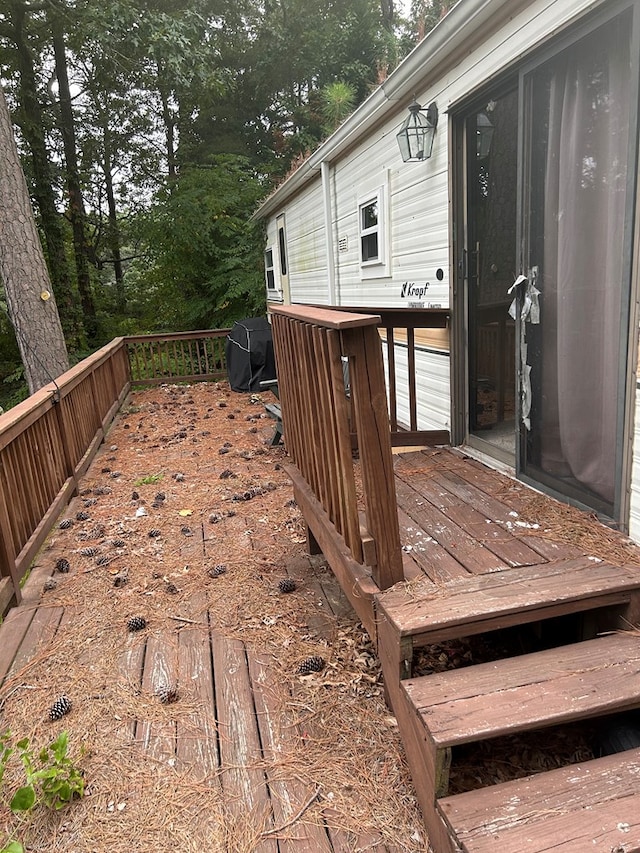 wooden terrace featuring area for grilling