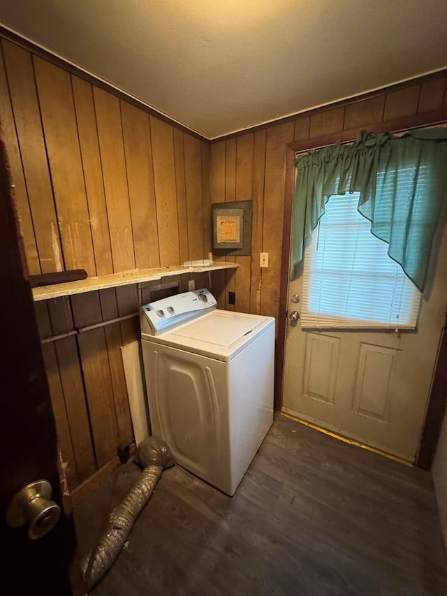 washroom with washer / clothes dryer, dark hardwood / wood-style floors, and wood walls