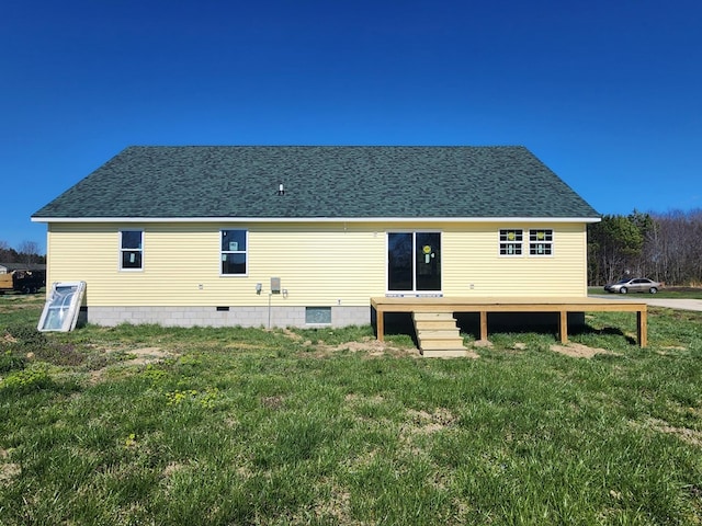 rear view of house with a lawn and a wooden deck