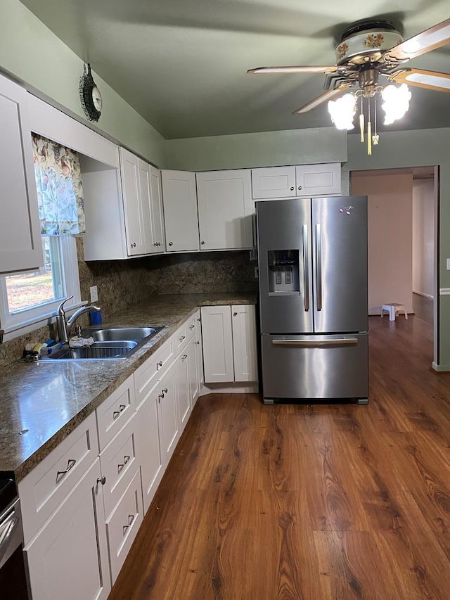 kitchen with stainless steel fridge with ice dispenser, tasteful backsplash, white cabinetry, and sink