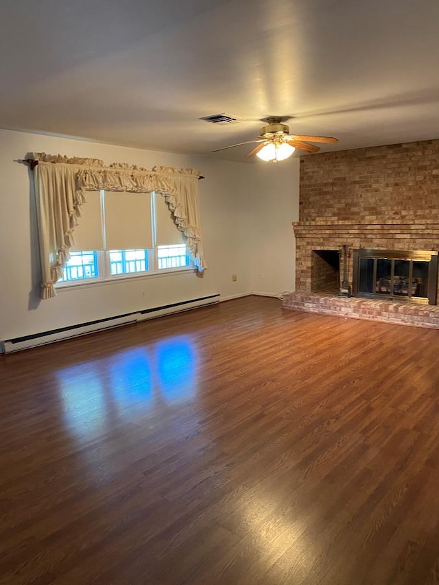 unfurnished living room featuring ceiling fan, a baseboard radiator, dark hardwood / wood-style floors, and a brick fireplace