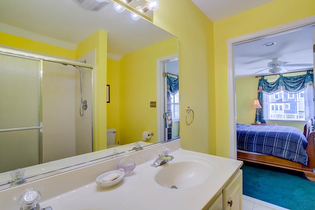 6180 Marsh Island Dr, Chincoteague, VA 23336 - ensuite bathroom with vanity, a shower stall, toilet, tile patterned floors, and ceiling fan