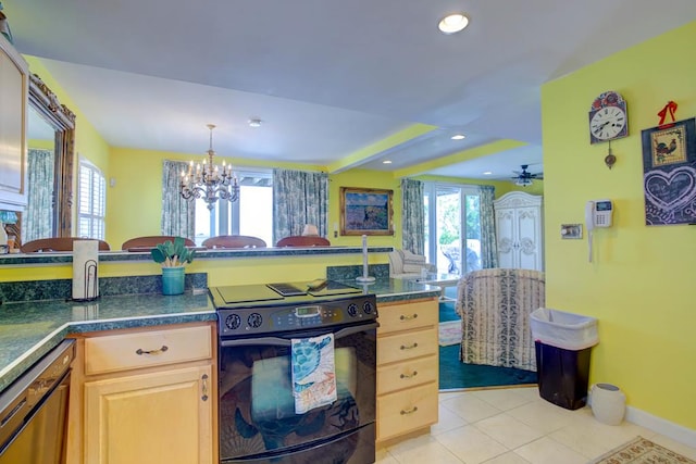 6180 Marsh Island Dr, Chincoteague, VA 23336 - kitchen with black range with electric stovetop, light tile patterned floors, a chandelier, dark countertops, and light brown cabinetry