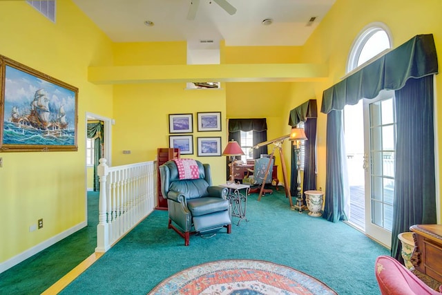 6180 Marsh Island Dr, Chincoteague, VA 23336 - sitting room featuring carpet, a ceiling fan, an upstairs landing, and baseboards