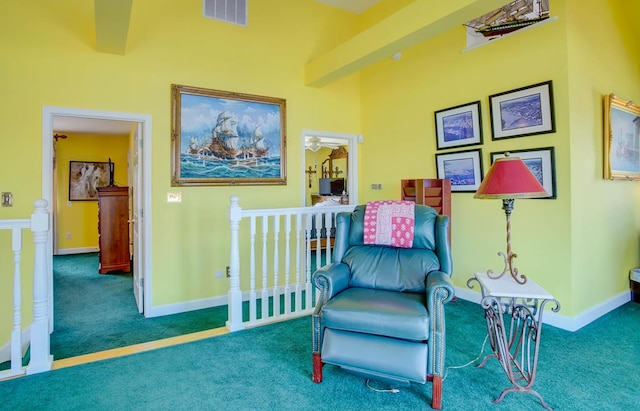 6180 Marsh Island Dr, Chincoteague, VA 23336 - living area featuring carpet floors, an upstairs landing, and baseboards