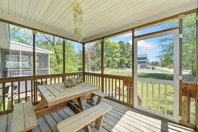 sunroom / solarium featuring outdoor dining space
