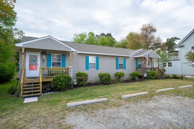 view of front of home featuring a front lawn, a porch, and uncovered parking