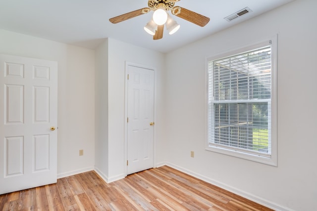 unfurnished bedroom with visible vents, light wood-style floors, baseboards, and multiple windows