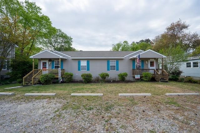 single story home featuring a front lawn, a porch, and uncovered parking