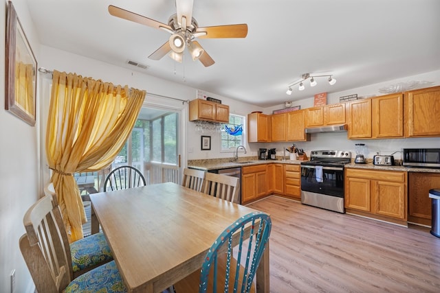 kitchen with visible vents, ceiling fan, light wood-type flooring, under cabinet range hood, and stainless steel appliances
